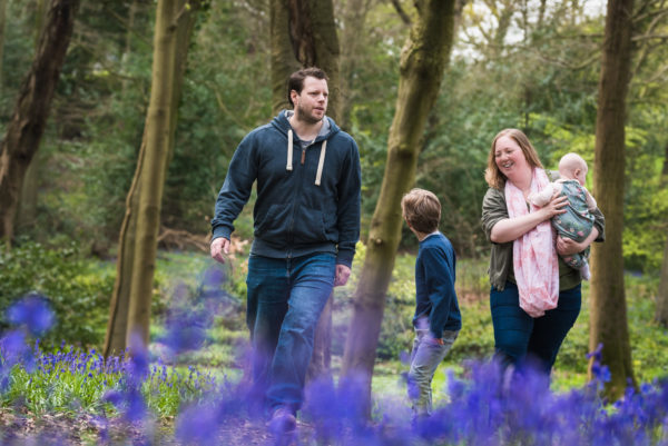 Family walking bluebell woods during spring photoshoot in Wallingford